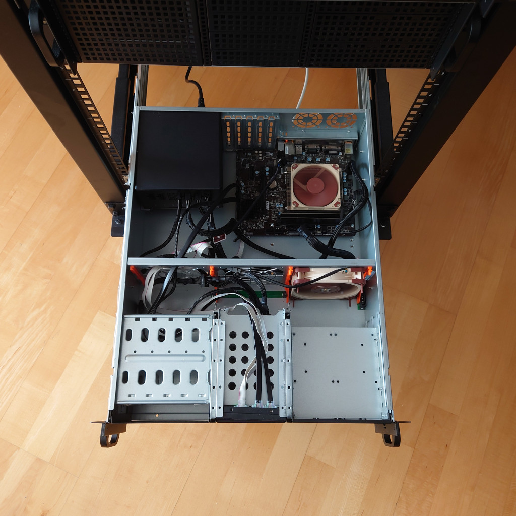 A picture of a 19 inch rack mounted server. It shows a 3U case, with a full size ATX PSU and mATX mainboard. Quite recognizable are beige-and-brown colored case and CPU fans