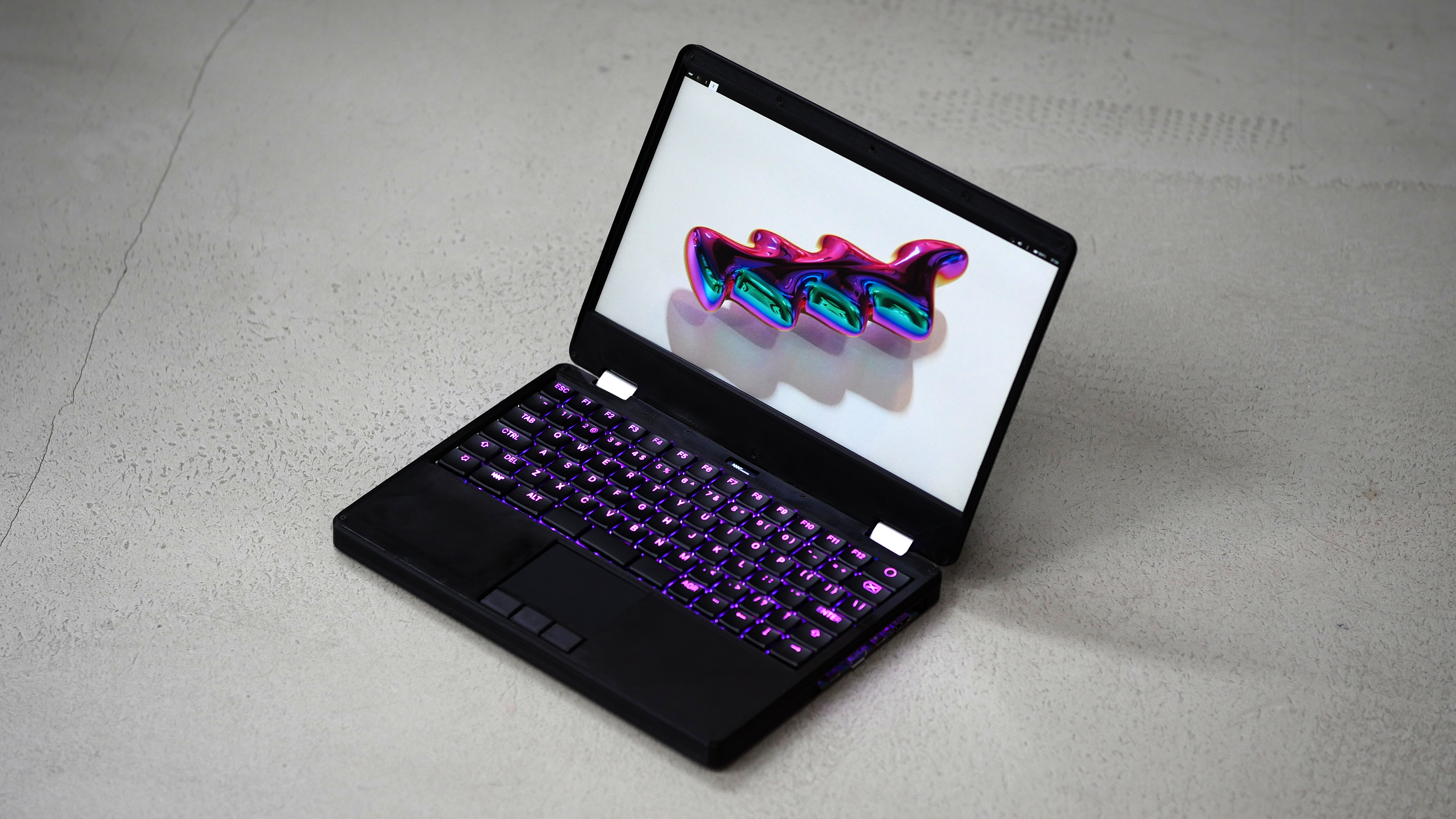 A picture of the MNT Reform Next laptop. It's a 12.5 inch model, a bit thicker than other modern laptops.