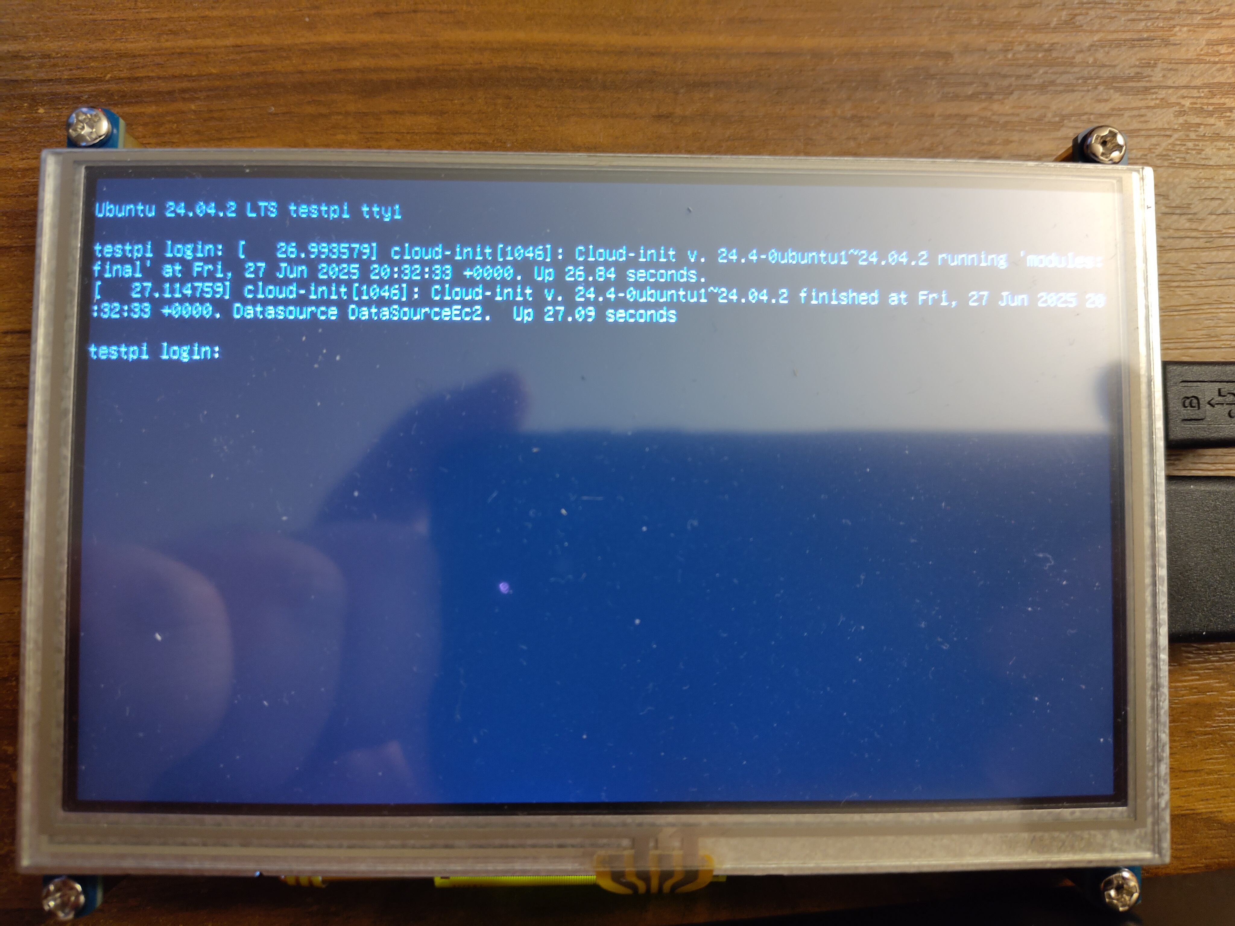 A picture of a screen showing the final lines of an Ubuntu boot. It shows the Ubuntu version as 24.02.2 LTS, some lines indicating that cloud-init ran successfully and finally a login prompt for the host testpi.