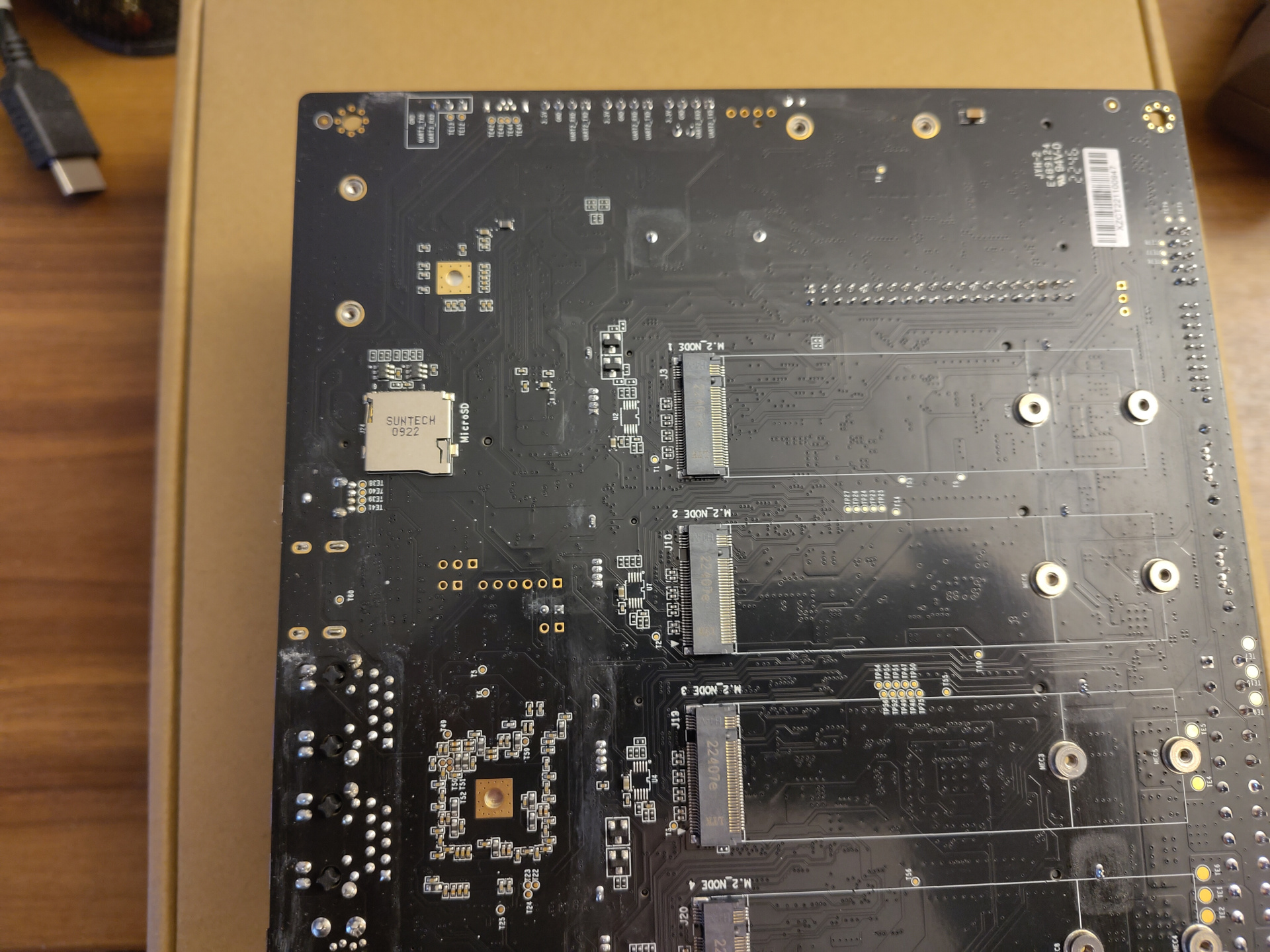 A picture of the backside of the board. It shows exactly what the schematics above showed: Four M.2 slots for NVMe SSDs and a single lone SD card slot, definitely too far away from the edge of the board to be accessible while the board is mounted in a case.